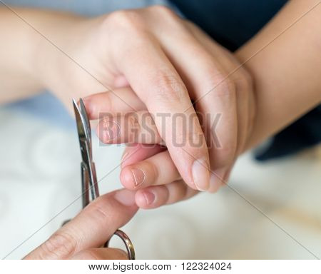 Nail clippers child. My mother helps the child.