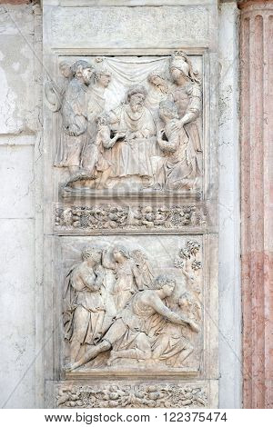 BOLOGNA, ITALY - JUNE 04: Jacob and the Angel by Niccolo Tribolo up and Benjamin brings the cup to Pharaoh by Francesco da Milano, left door of San Petronio Basilica in Bologna, Italy, on June 04,2015