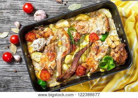 rabbit braised with sour cream and tomatoes peppers garlic potatoes top view