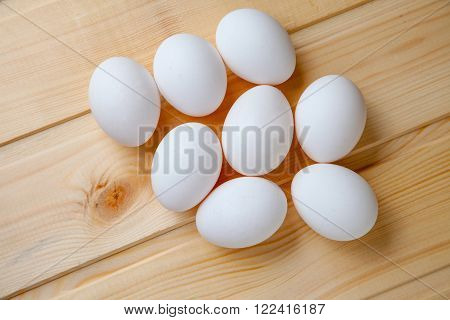 Fresh farm eggs on a wooden rustic background