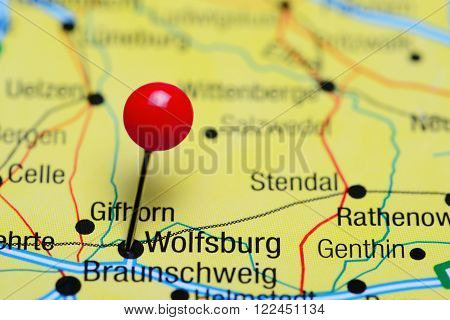 Photo of pinned Wolfsburg on a map of Germany. May be used as illustration for traveling theme.