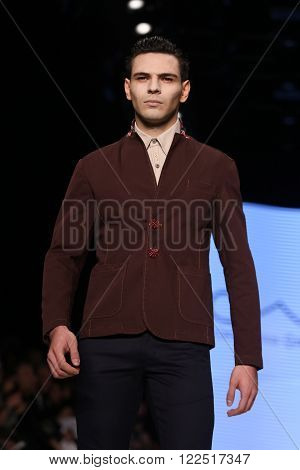 ISTANBUL, TURKEY - MARCH 17, 2016: A model showcases one of the latest creations of Can Yunus Cetinkaya in Mercedes-Benz Fashion Week Istanbul