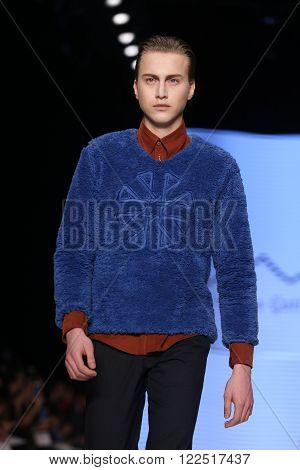 ISTANBUL, TURKEY - MARCH 17, 2016: A model showcases one of the latest creations of Can Yunus Cetinkaya in Mercedes-Benz Fashion Week Istanbul