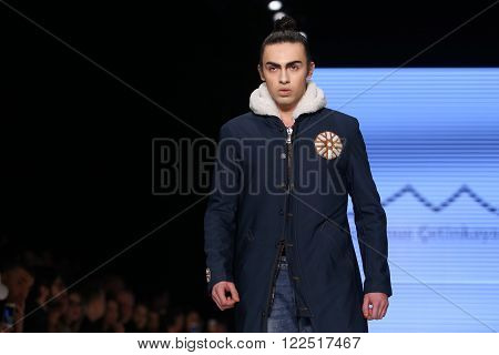 ISTANBUL, TURKEY - MARCH 17, 2016: A model showcases one of the latest creations of Can Yunus Cetinkaya in Mercedes-Benz Fashion Week Istanbul
