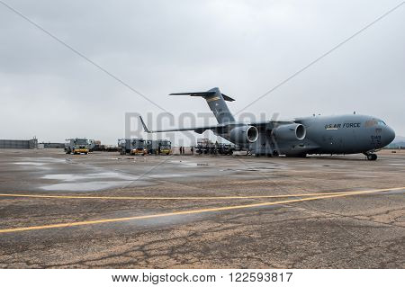 Busan, South Korea - 28 February 2012: A C-17 Globemaster is getting refueled by fuel trucks.