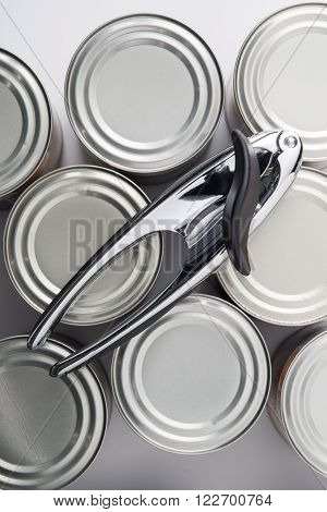 Overhead Shot Of Can Opener On Tin Cans