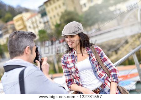 Man taking picture of girlfriend, week-end travel