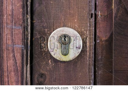 Old latch on red board wall closeup