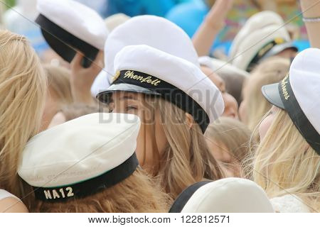 STOCKHOLM SWEDEN - JUN 10 2015: Group of happy teenage girls wearing white graduation caps celebrating the graduation after finishing high school at the school Globala gymnasiet June 10 2015 Stockholm Sweden