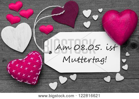 Label With Pink Textile Hearts On Wooden Gray Background. German Text Am 8. Mai Ist Muttertag Means 8th May Is Mothers Day. Retro Or Vintage Style. Black And White Image With Colored Hot Spot.
