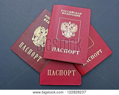Several passports of a citizen of Russian Federation on black background. The inscriptions in Russian 