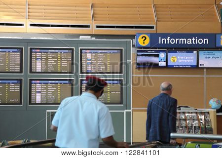Vancouver, BC Canada - September 13, 2014 : People asking some information insdie the YVR airport in Vancouver BC Canada. 