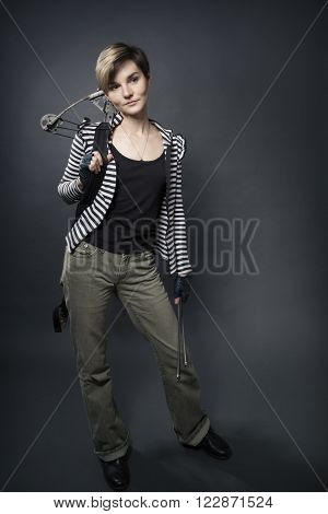 young woman with a big camouflage paint  crossbow
