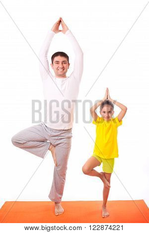 Handsome man father dad practicing yoga with his cute adorable beautiful daughter isolated on white background