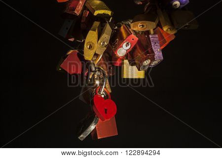 FRANKFURT, GERMANY - MAR 15: Lovelocks on the old bridge in Frankfurt illuminated at night. March 15, 2016 in Frankfurt Main, Germany