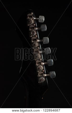 the mechanism of a tension of strings on the fingerboard of an old vintage electric guitar