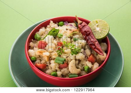 Rava Upma - Popular south Indian breakfast wiih semolina and vegetables, selective focus, Upma or upama is a South Indian breakfast, cooked from dry roasted semolina. seasonings of vegetables