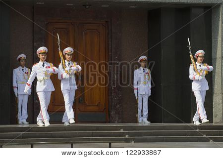 HANOI, VIETNAM - JANUARY 10, 2016: Changing of the guard at the door of the Ho Chi Minh mausoleum in Hanoi. The Ho Chi Minh mausoleum is the main attraction of Vietnam