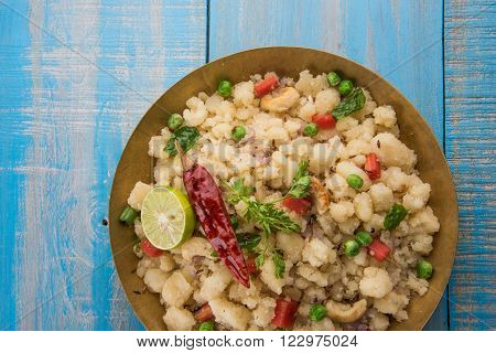 Rava Upma - Popular south Indian breakfast wiih semolina and vegetables, selective focus, Upma or upama is a South Indian breakfast, cooked from dry roasted semolina. seasonings of vegetables