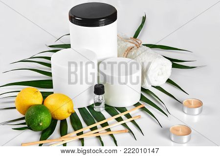 White bottles and two whole lemon and lime isolated on white background. The concept for advertising cosmetics. Still life. Copy space