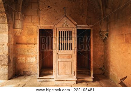 ORADOUR SUR GLANE, FRANCE - December 03, 2017 : inside the church where were burned women and children during the massacre of the population by the Nazis on June 10, 1944, the wooden confessional retained almost intact since that time