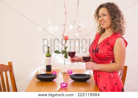 Portrait beautiful woman smile with a pink rose at restaurant on Valentines Day