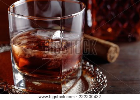 Glass Of  Whiskey And Cigar On Old Wooden Table.