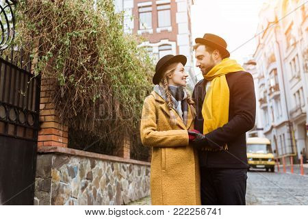 beautiful young couple in autumn outfit looking at each other