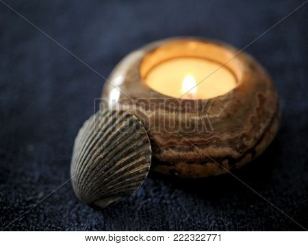 Stone Tea Light Candle and Ocean Shell on Navy Blue