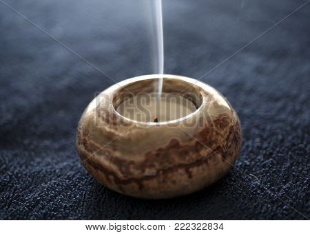 Burned Out Stone Tea Light Candle Smoke  on Navy Blue