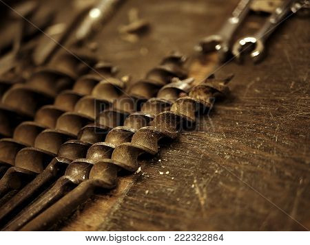 Old Rusty Drill Bits and Wrenches on Work Bench in Garage