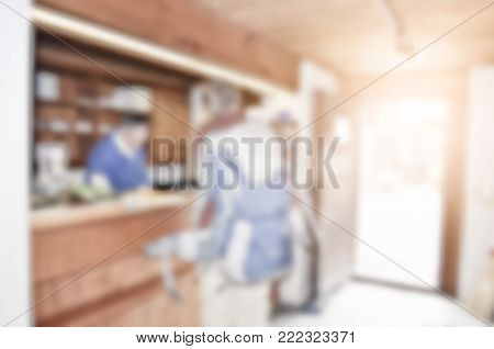 Male guest filling up a formular at hotel counter with blurred background concept.