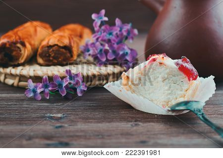 tender cake with a spoon on a wooden background. Selective focus, close up.