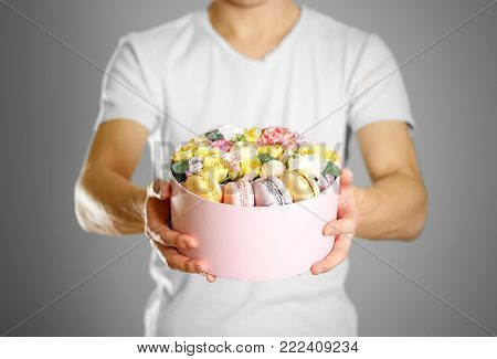 Man Holding Flowers And Cookies In A Box. Hands Holding Rocket In A Hatbox