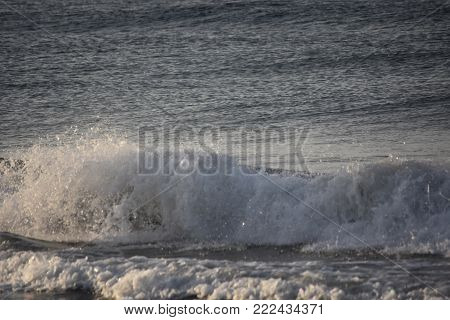 Beautiful photo of a large wave crashing in Santa Barbara
