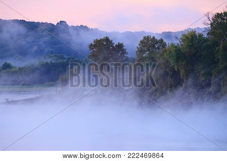 Fog over Truman Lake with pastel colors in the sky.  Truman lake is in the Lake of the Ozarks area of Missouri.