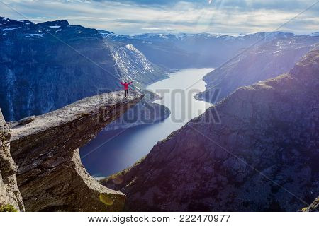 Happy Woman standing on Trolltunga in Norway