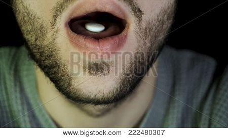 Bearded Man Swallows A Pill. Close Up Of Man Showing Tablet On The Tongue And Swallows It, The Conce
