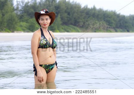Woman shape huge and hat bikini relax on beach at Ban Krut Beach, Prachuap Khirikhan Province Thailand