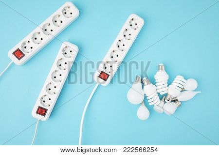 flat lay with extension cords and different light bubs isolated on blue
