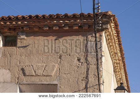 Corner of an old stone house next to a group of swallows