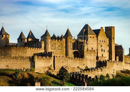 Carcassonne Medieval Fortress Highlighted Night View With Moon In Blue Sky