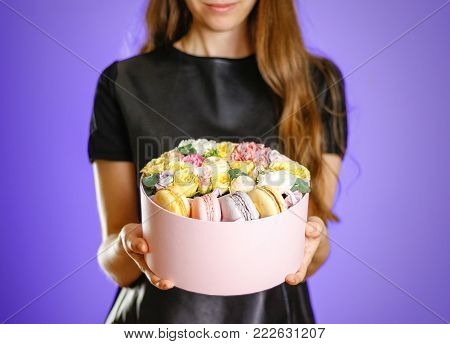 Girl Holding Flowers And Cookies In A Box. Hands Holding Rocket In A Hatbox