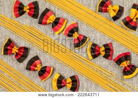 Assortment of different shape pastas over wooden background