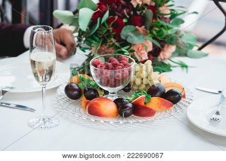 Weddings toast. glasses with champagne drink in bride and groom hands. Happy newlyweds drinking at ceremony. Loving couple created new family. Decorated alcohol drinks