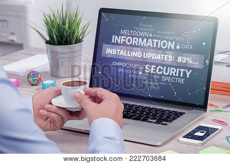 Man waiting update against Meltdown and Spectre vulnerability on laptop to be installed meanwhile drinking a cup of coffee. Information security concept.