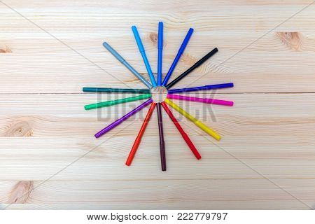 colored felt-tip pens on a wooden table