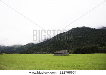 View Landscape Of Mountain And Grass Field Beside Road At Countryside At Biberwier, Austria