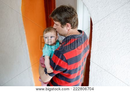 Happy proud young father having fun with newborn baby daughter, family portrait togehter. Dad with baby girl, love. Bonding, family, new life