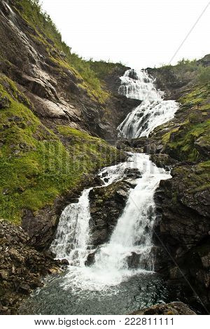 Kjosfossen waterfall near Flam to Myrdal Flamsbana Railway Line, Norway. Kjosfossen waterfall in august. Scandinavia landscape. Beautiful Norway nature.